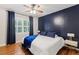 Spacious bedroom with hardwood floors, blue accent wall, and bright windows at 6878 Brandon Mill Rd, Sandy Springs, GA 30328