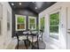 Cozy breakfast nook features a modern table and chairs, as well as an abundance of natural light at 6878 Brandon Mill Rd, Sandy Springs, GA 30328