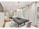 Dining room boasts a modern chandelier, hardwood floors, and neutral decor at 6878 Brandon Mill Rd, Sandy Springs, GA 30328