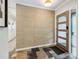 Entryway featuring a modern wood door, striking floor tile, and textured wallpaper at 6878 Brandon Mill Rd, Sandy Springs, GA 30328