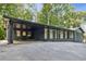 A dark blue and white home with a covered parking area with asphalt driveway at 6878 Brandon Mill Rd, Sandy Springs, GA 30328