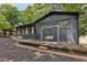 Back of the house showing dark brick, a covered porch with steps, and backyard swing at 6878 Brandon Mill Rd, Sandy Springs, GA 30328