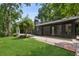 Exterior view of the home showcasing the lawn, patio, and black trim at 6878 Brandon Mill Rd, Sandy Springs, GA 30328