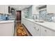 Bright kitchen with long countertops, modern backsplash, and stainless steel appliances at 6878 Brandon Mill Rd, Sandy Springs, GA 30328