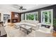 Bright living room features a fireplace, large sofa, ceiling fan and large windows at 6878 Brandon Mill Rd, Sandy Springs, GA 30328