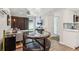Open-concept living room featuring a dining area, television, and stainless steel kitchen appliances at 6878 Brandon Mill Rd, Sandy Springs, GA 30328