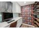 Home office featuring a built-in desk, wood-look floors, and bookshelf-themed wallpaper at 6878 Brandon Mill Rd, Sandy Springs, GA 30328
