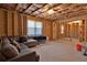 Unfinished basement with a gray sofa, wooden beams, and a window at 1054 Mackets Ct, Atlanta, GA 30354