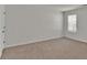 Bright bedroom with a window offering natural light, neutral walls and plush carpeting at 1054 Mackets Ct, Atlanta, GA 30354