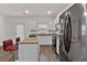 Modern kitchen features white cabinets, stainless steel appliances, granite countertops, and wood floors at 1054 Mackets Ct, Atlanta, GA 30354