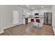 Bright kitchen with white cabinets, stainless steel appliances, granite countertops and wood floors at 1054 Mackets Ct, Atlanta, GA 30354