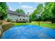 Spacious backyard features a basketball court, lush lawn and mature trees at 265 Landfall Rd, Atlanta, GA 30328