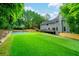 Wide backyard with basketball court, artificial lawn, and wooded privacy at 265 Landfall Rd, Atlanta, GA 30328