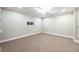 Finished basement with neutral carpet, recessed lighting, and a wall-mounted bracket at 265 Landfall Rd, Atlanta, GA 30328