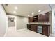 Basement bar area with dark wood cabinets, mini fridge, and recessed lighting at 265 Landfall Rd, Atlanta, GA 30328