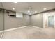 Finished basement with neutral carpet, recessed lighting, ceiling fan, and an open doorway at 265 Landfall Rd, Atlanta, GA 30328
