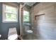 Tiled shower with glass door and window, accompanied by toilet and neutral color scheme at 265 Landfall Rd, Atlanta, GA 30328