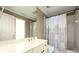 Bathroom featuring a white vanity, decorative mirror, and a shower with patterned curtain at 265 Landfall Rd, Atlanta, GA 30328