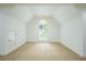 Bright bedroom featuring neutral carpet, white walls, dormer ceiling, and large window at 265 Landfall Rd, Atlanta, GA 30328