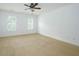 Spacious bedroom with neutral carpet, white walls, and bright natural light from multiple windows at 265 Landfall Rd, Atlanta, GA 30328