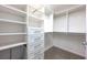 Spacious walk-in closet with custom shelving, built-in drawers, and chrome hardware at 265 Landfall Rd, Atlanta, GA 30328