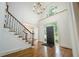 Bright foyer featuring hardwood floors, staircase, chandelier, and elegant front door at 265 Landfall Rd, Atlanta, GA 30328