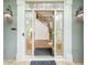Elegant front door with decorative glass panels and sidelights, offering a glimpse of the staircase at 265 Landfall Rd, Atlanta, GA 30328