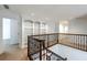 Upstairs hallway featuring hardwood railing, carpeted floor and built in shelves at 265 Landfall Rd, Atlanta, GA 30328