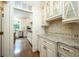 Gourmet kitchen featuring custom cabinets, granite countertops, stainless steel appliances, and a tile backsplash at 265 Landfall Rd, Atlanta, GA 30328