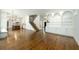 Open living room showing kitchen, staircase, shelving, and beautiful hardwood floors at 265 Landfall Rd, Atlanta, GA 30328