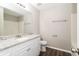 Bright bathroom featuring white cabinets, granite countertops and a large mirror at 5612 Festival Ave, Fairburn, GA 30213