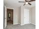 Bedroom featuring neutral walls, plush carpet, and a ceiling fan for added comfort at 5612 Festival Ave, Fairburn, GA 30213