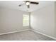 Bright bedroom showcasing a window, neutral walls, and carpet flooring at 5612 Festival Ave, Fairburn, GA 30213