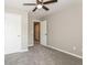 Neutral bedroom boasts plush carpet flooring, a ceiling fan, and ample doorway access at 5612 Festival Ave, Fairburn, GA 30213