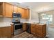 Well-equipped kitchen with stainless steel appliances and wood cabinetry at 5612 Festival Ave, Fairburn, GA 30213