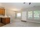 Bright living room adjacent to kitchen featuring neutral paint and abundant natural light at 5612 Festival Ave, Fairburn, GA 30213