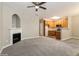 Open-concept living room with a fireplace and views into the adjacent kitchen at 5612 Festival Ave, Fairburn, GA 30213