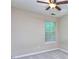This bedroom features neutral walls, carpeted floors, a window with blinds, and a ceiling fan at 5640 Terremont Cir, Norcross, GA 30093