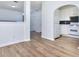 Open dining area with wood floors that transitions to a kitchen with white cabinets and appliances at 5640 Terremont Cir, Norcross, GA 30093