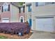 Exterior view showing the townhome's facade, garage, and well-kept landscaping at 5640 Terremont Cir, Norcross, GA 30093