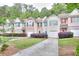 A row of townhomes with well-maintained lawns, driveways, and manicured bushes at 5640 Terremont Cir, Norcross, GA 30093