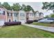 A row of townhomes with well-maintained lawns, driveways, and manicured bushes at 5640 Terremont Cir, Norcross, GA 30093