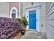 Bright blue front door with decorative trim and surrounding landscape at 5640 Terremont Cir, Norcross, GA 30093