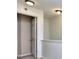 Neutral hallway landing with open door, carpeted floors, and contemporary lighting at 5640 Terremont Cir, Norcross, GA 30093