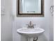 Small, pedestal sink in the powder room featuring classic fixtures at 5640 Terremont Cir, Norcross, GA 30093