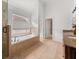 Bright bathroom featuring a soaking tub, granite counters and a walk-in shower at 121 Fulton Se Way, Atlanta, GA 30312