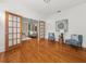 Bright bonus room with French doors, two chairs, an accent table, and beautiful hardwood floors at 121 Fulton Se Way, Atlanta, GA 30312