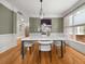 Bright dining room featuring hardwood floors, modern lighting, and a large window for plenty of natural light at 121 Fulton Se Way, Atlanta, GA 30312