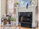 Elegant fireplace and mantle area with artful decor and a decorative fireplace screen at 121 Fulton Se Way, Atlanta, GA 30312
