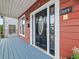 The front door of the home is black with an oval window, framed by white trim, and a blue front porch at 121 Fulton Se Way, Atlanta, GA 30312